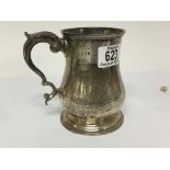 A silver tankard with London hallmarks with a scroll handle weight
