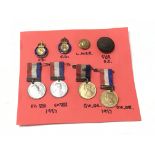 A collection of medals badges and buttons including two civil defence badges, buttons and coronation