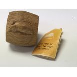 A mouse man oak napkin ring with accompanying care booklet.