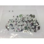 A bag of loose mixed stones including CZs, rubies, emeralds, sapphire and jade, approx 75.00ct.