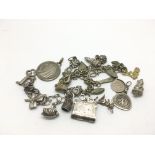 A bag of charms including some silver.