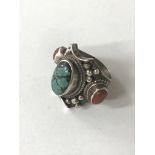 A silver ring set with cornelian and a turquoise coloured central stone, approx size P.