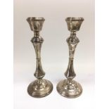 A pair of silver candlesticks of waisted form, Birmingham hallmarks, approx height 26cm.