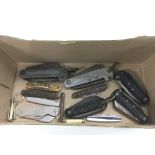 A small collection of penknives including some military examples.