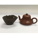 A small terracotta teapot and a tea bowl (2).