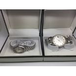 Two Seiko watches comprising a gents and a ladies example with silver tone dials and bracelets.