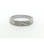 An 18ct white gold ring with seven princess cut diamonds, approx 0.20ct, ring size approx J