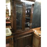 A late Victorian walnut bookcase with a cornice above glazed doors a drawer and cupboards 89cm