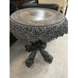 A Anglo Indian circular occasional table profusely carved with stylised animals . 70 cm by 60 cm .