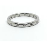 A platinum and diamond eternity ring, ring size approx O/P