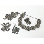 A collection of marcasite jewellery consisting of a bracelet, brooches and a dress clip