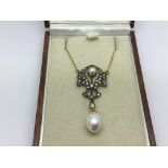A boxed necklace set with pearls and diamonds.