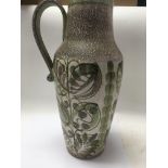 A Denby Glynn ware pitcher decorated ingreen and brown glaze, impressed marks to the base .