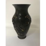 A Japanese bronze vase with raised metal work flowers blossom and foliage . 20 cm .