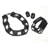 A black glass jewellery set including choker necklace, bracelet and earrings