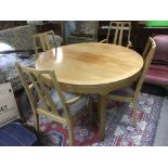 A Parker Knoll circular extending dining table and