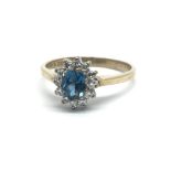 A 9ct yellow gold ring with diamond and topaz cluster, ring size approx J