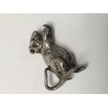 A small silver casting in the form of a mouse.