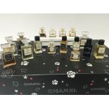 A collection of Chanel miniature sample shop only display bottles some open. In a Chanel box with