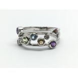 A 9ct white gold ring having multi-coloured stones, ring size approx M