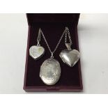 Three silver lockets on silver chains, in box