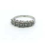 An 18ct white gold ring having seven diamonds, approx 0.23ct, approx size M/N