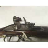 A Brown Bess flintlock Musket Rifle the action with tower marks brass fittings.