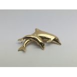 A yellow metal dolphin pendant, approx 4g.