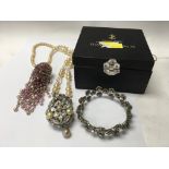 Three items of costume jewellery comprising a bracelet necklace and head piece.