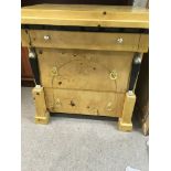 An empire style maple chest of drawer fitted with three drawers flanked by classic columns. 50 cm by