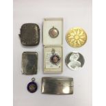 A collection of silver items including vesta cases, medallions and commemorative coins.