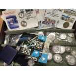 A case of mixed silver and commemorative coins and first day covers.