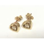 A pair of 18carat gold earrings of heart shape set with diamonds. Weight 2.5g