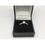 An 18ct white gold solitaire 55 point diamond ring, approx 3g and approx size N.