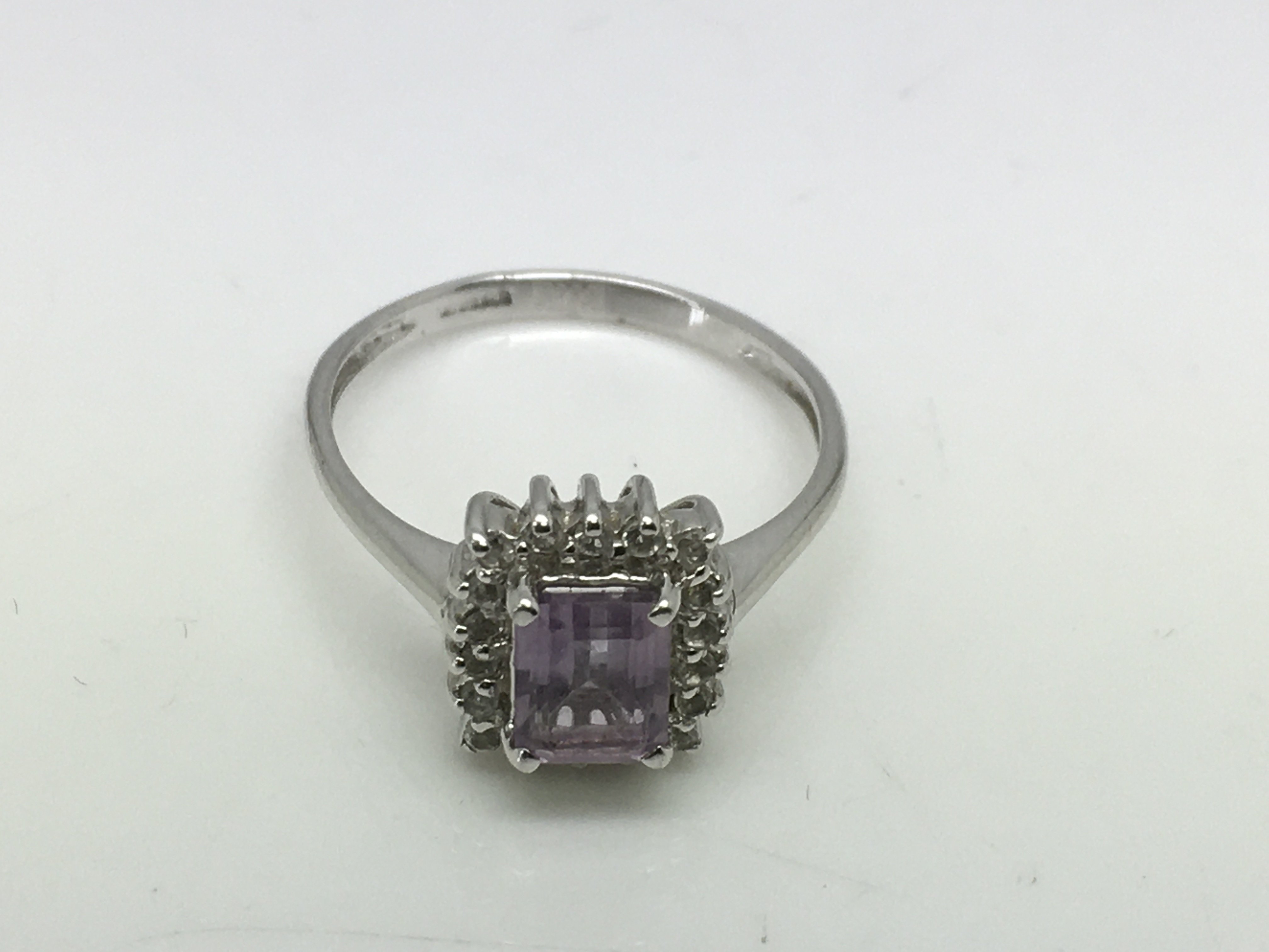 A 9ct white gold ring set with an amethyst type stone surrounded by diamonds, approx 2.6g and approx