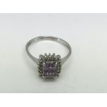 A 9ct white gold ring set with an amethyst type stone surrounded by diamonds, approx 2.6g and approx