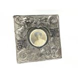 A silver plated Oriental style photo frame surmounted with dragons and symbols, approx 20cm in