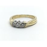 An 18ct yellow gold and three stone diamond ring, approx 0.20ct, ring size approx H