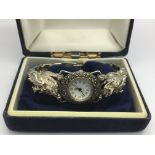 A solid silver and marcasite watch with a two dragon's head bracelet.