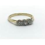 An 18ct yellow gold and three stone diamond ring, approx 0.33ct, ring size approx K/L