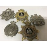Five Military Regimental Helmet plates including Essex Rifle Volunteers with makers name to the