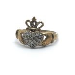 A 9ct yellow gold ring with Claddagh design, the heart having many small diamonds,ring size approx