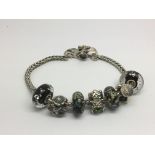 A silver troll bead bracelet with charms