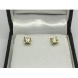 A boxed pair of 18ct gold four claw diamond solitaire ear studs, diamonds approx 0.86ct, approx 1.