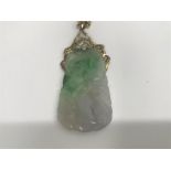 A jade pendant with gold and diamond mount on a 14 ct gold chain marked 585. 24 grams.