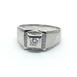 An 18ct white gold and approx 0.20ct diamond ring, with further diamonds to the shoulders, large