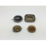 Four gold brooches comprising one set with amber, approx 17g.