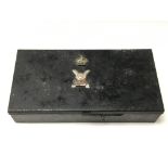 An old military tin box with silver and enamelled badge for the Scottish Lowland Regiment and a