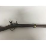 A replica Flint lock Muskett Rifle with brass fittings