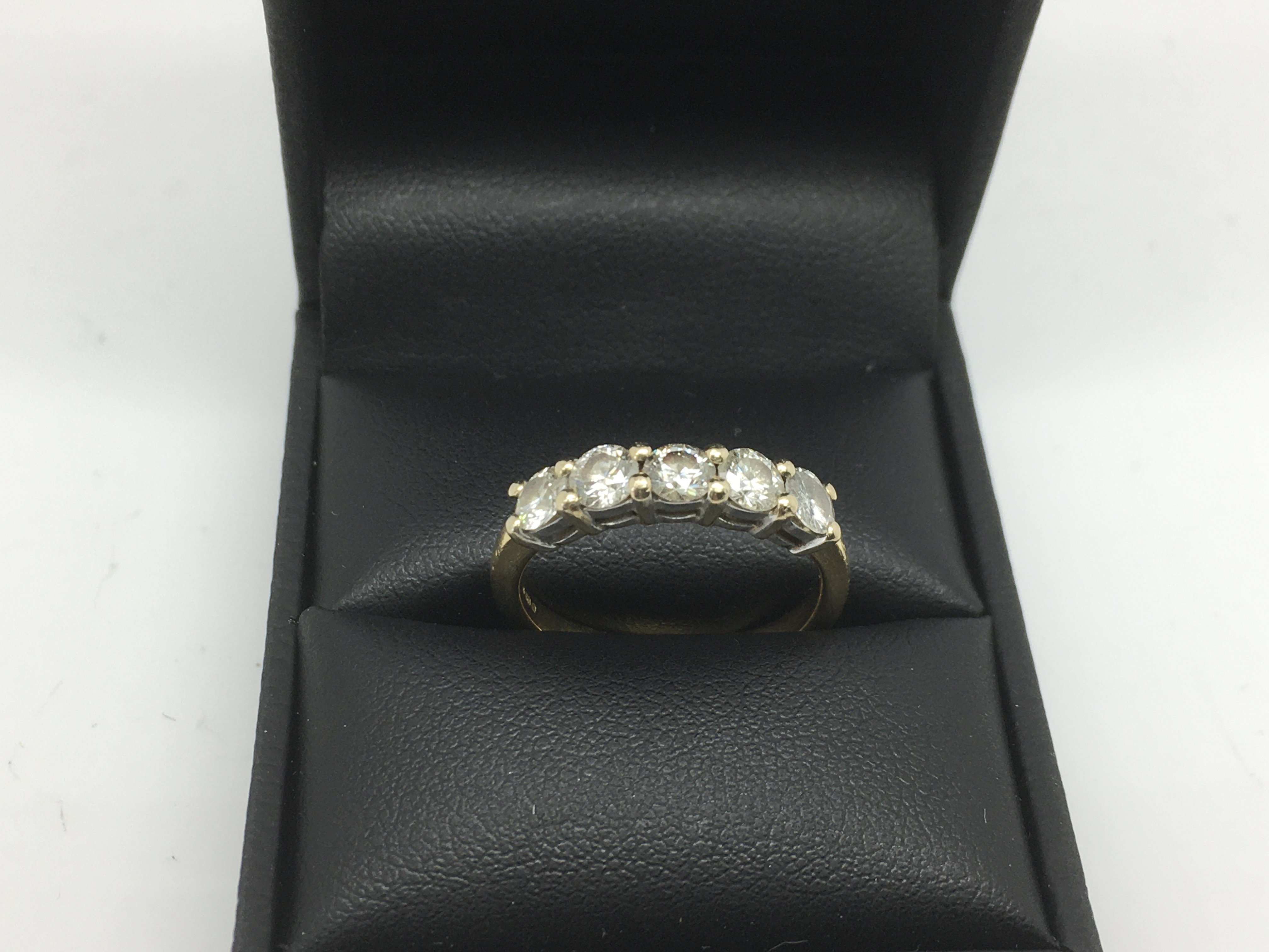 An 18ct gold ring set with a row of five brilliant cut diamonds, approx 3.8g and approx size N.